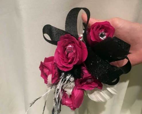 red and pink bouquet with black ribbon